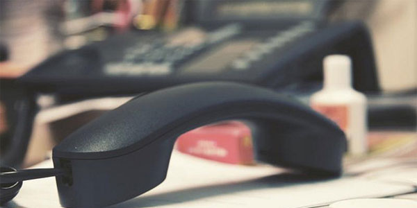 Telephone handset left off the hook on a desk