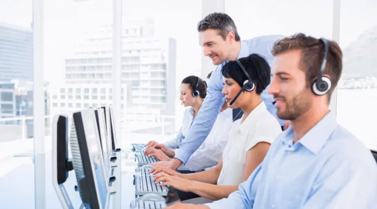 Banking support agents in headsets working at computers