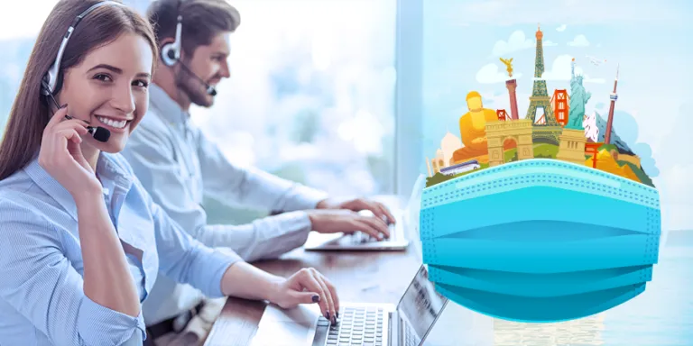 Travel agent in a headset beside a globe of landmarks wearing a face mask