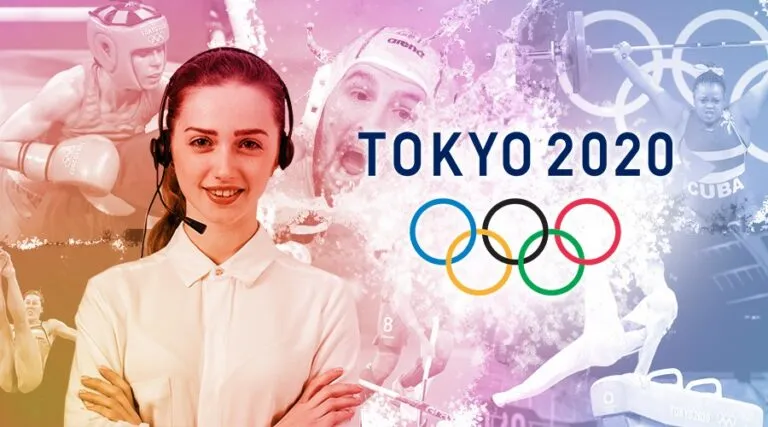 Smiling agent in a headset beside the Tokyo 2020 Olympic rings