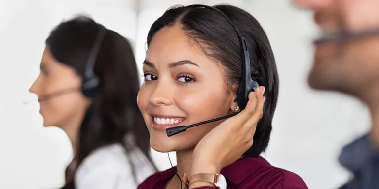 Smiling call center agent in a headset looking at the camera