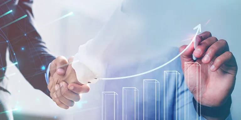 Handshake over a rising sales growth chart