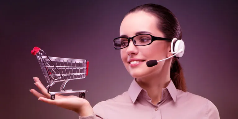 Retail support agent in a headset holding a small shopping cart