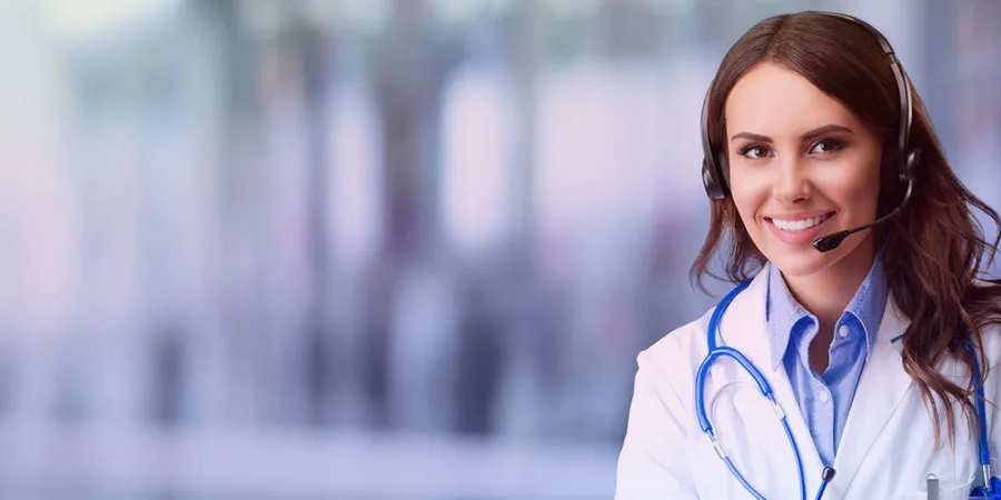 Smiling healthcare support agent in a headset with a stethoscope
