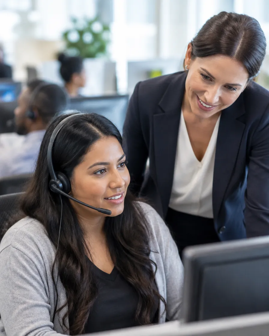 Collections team lead coaching agents on empathetic conversations